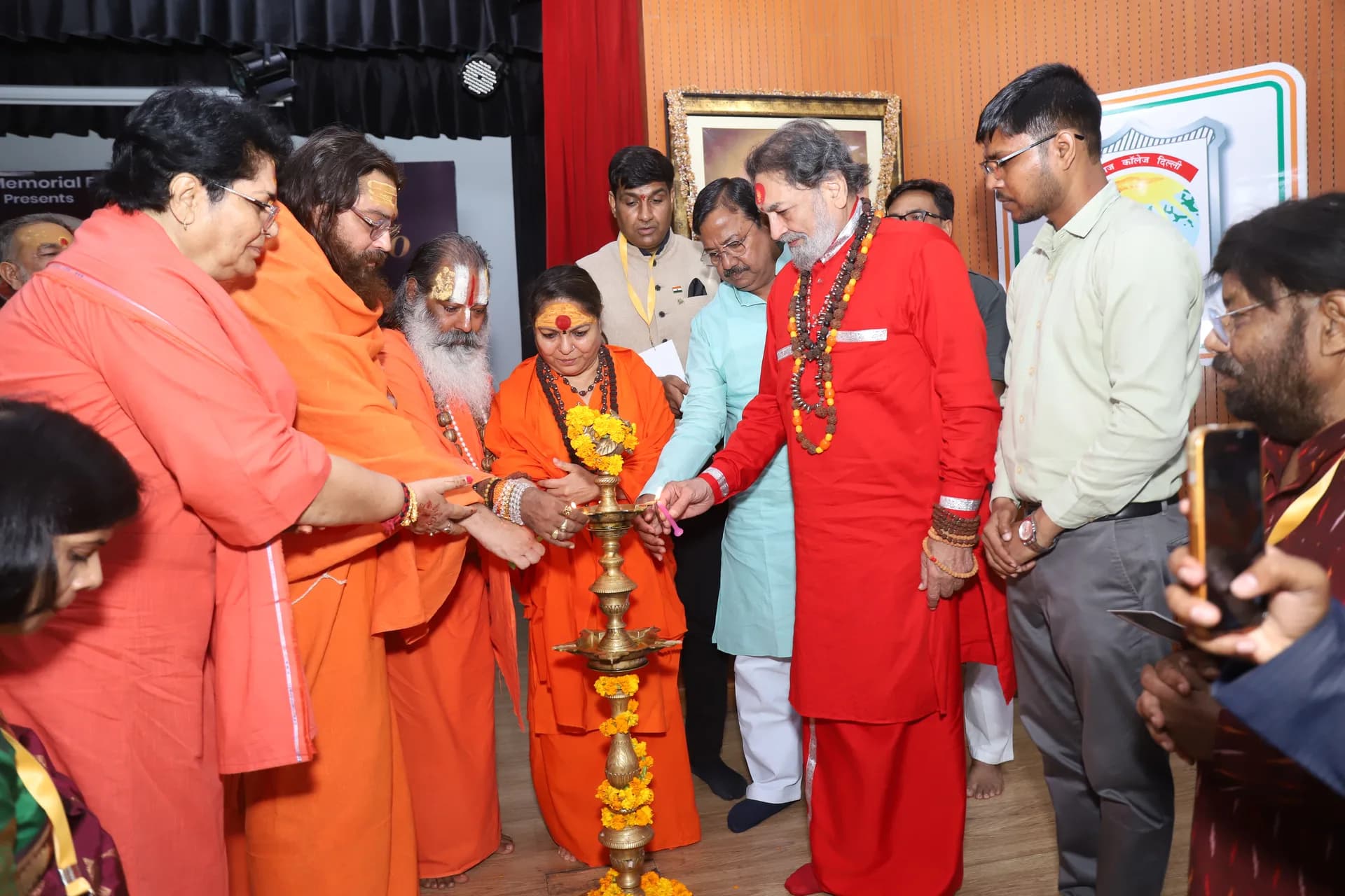 Saints and guests light the ceremonial lamp